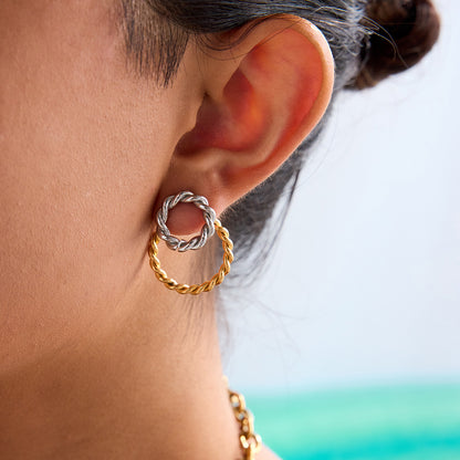 close-up detail of spiral two-tone metal hoops on model