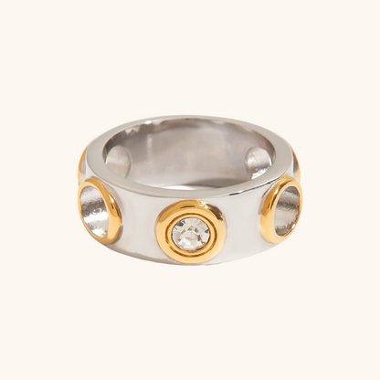 Chunky two-tone ring with gold-framed CZ stones on a silver band