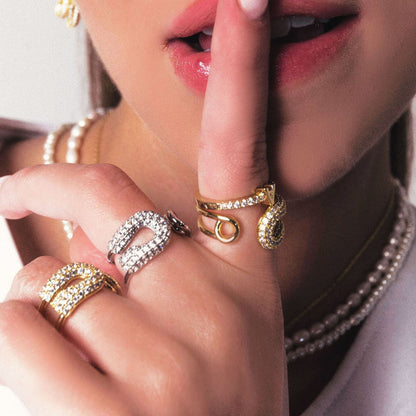 Close-up of model's hand wearing the spiral open ring under natural light.
