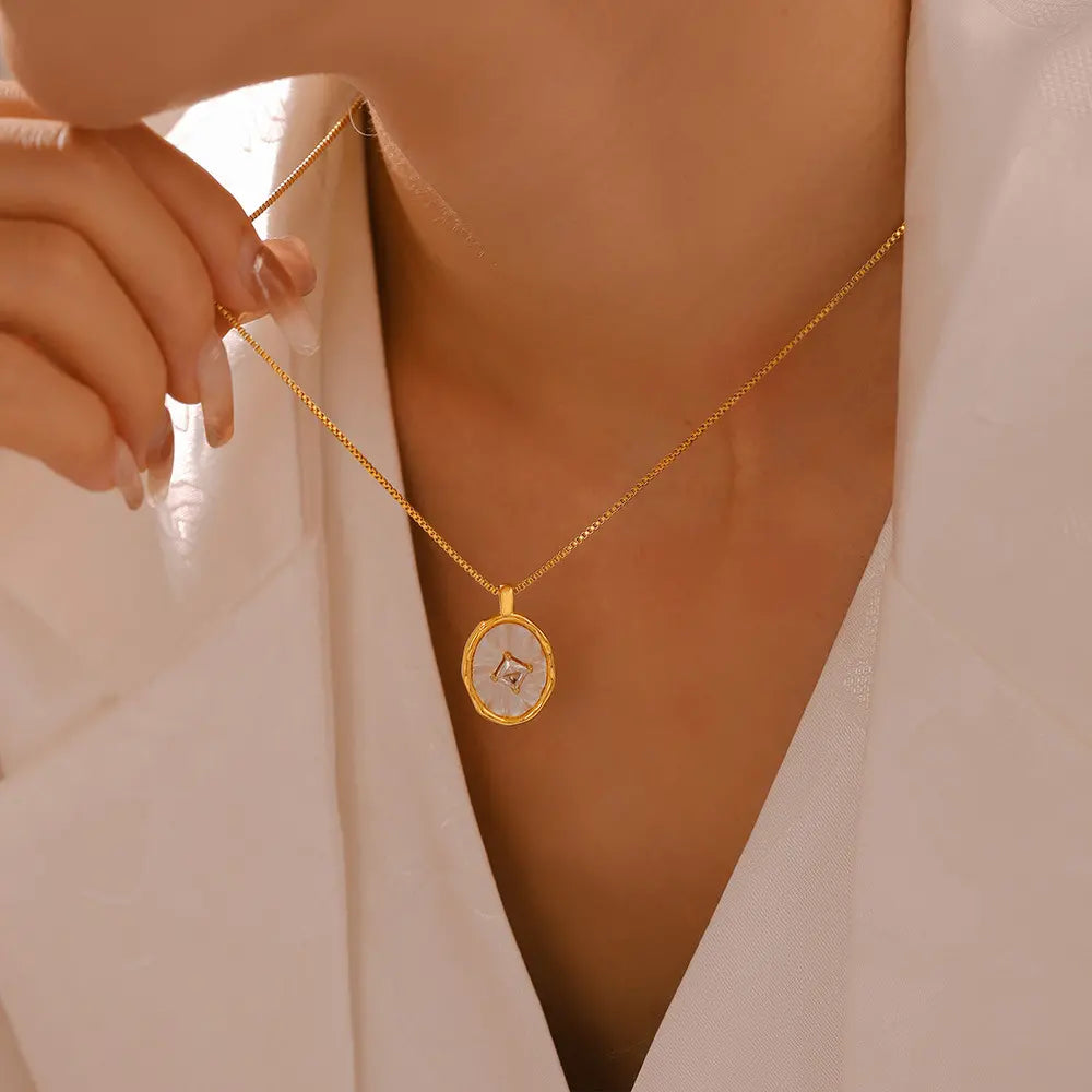 Model showcasing a chic 14K gold-plated white mother-of-pearl pendant necklace.