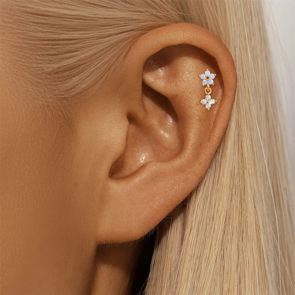 Model wearing 925 sterling silver 14k gold plated flower drop earrings with zirconia stones.