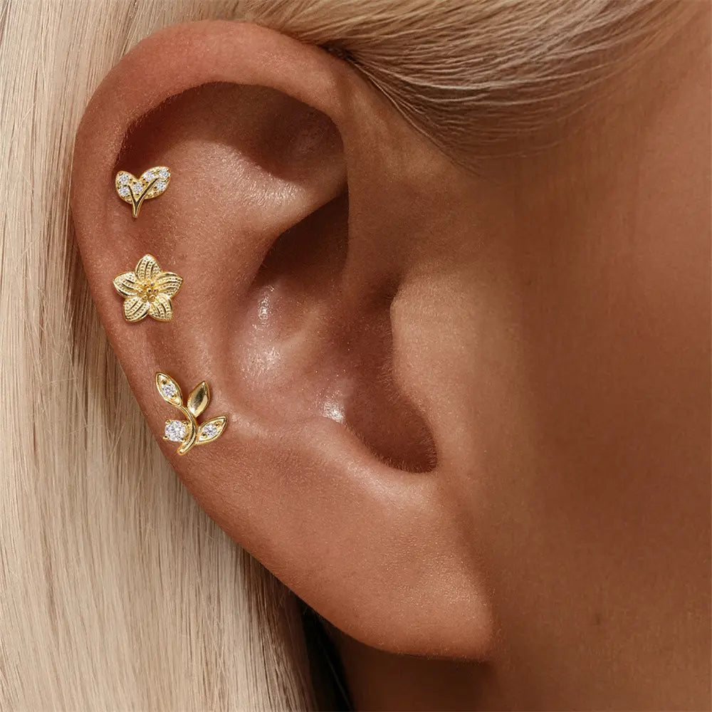 Model showcasing a 925 sterling silver three-piece earring set with CZ stones, floral and leaf design, gold-plated finish.