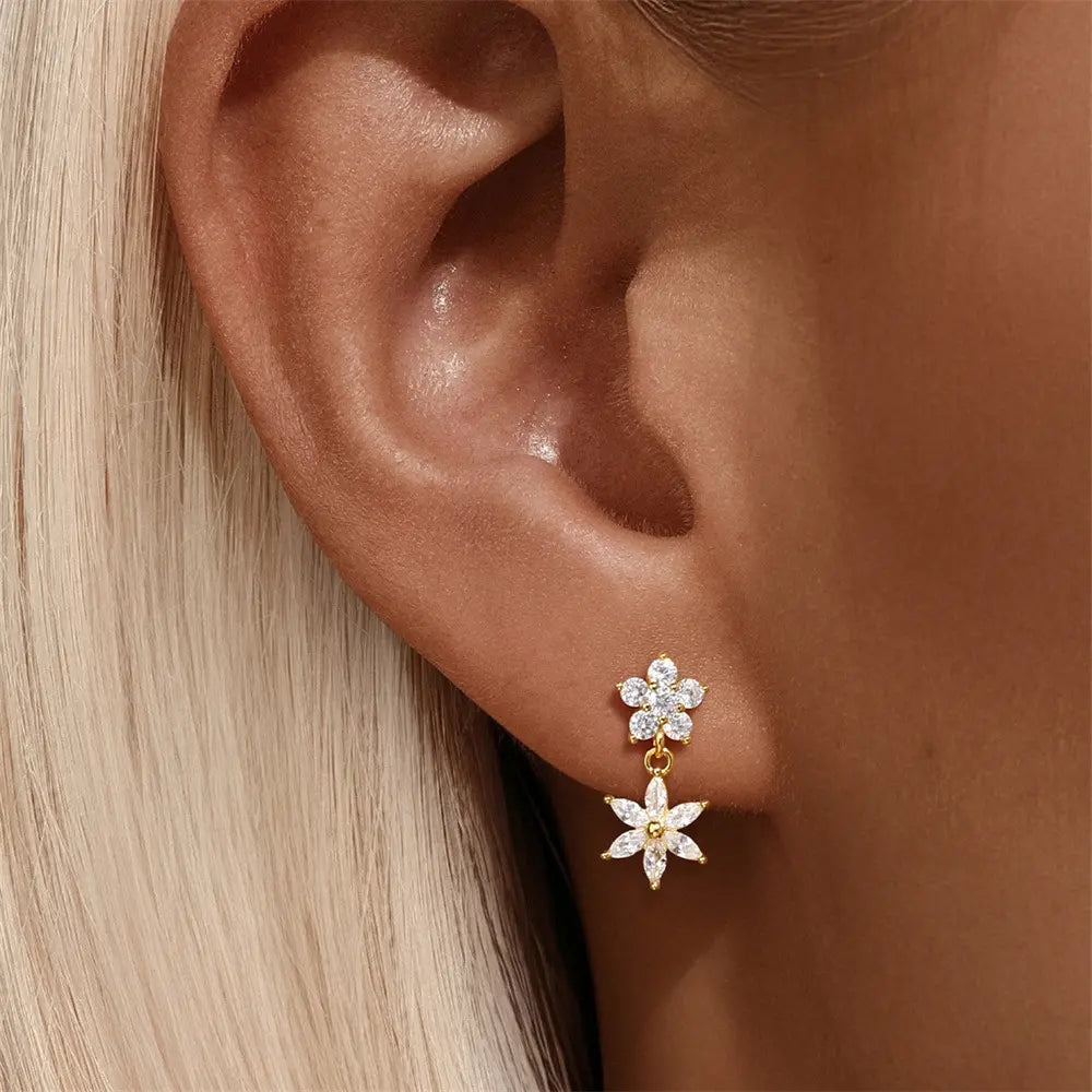 A model showcasing the beauty of 925 sterling silver flower zirconia drop earrings, adding sparkle to the look.