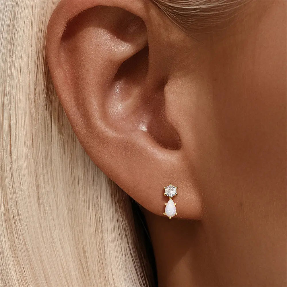 Model showcasing 925 sterling silver opal teardrop stud earrings with zirconia accents, worn on the ear.