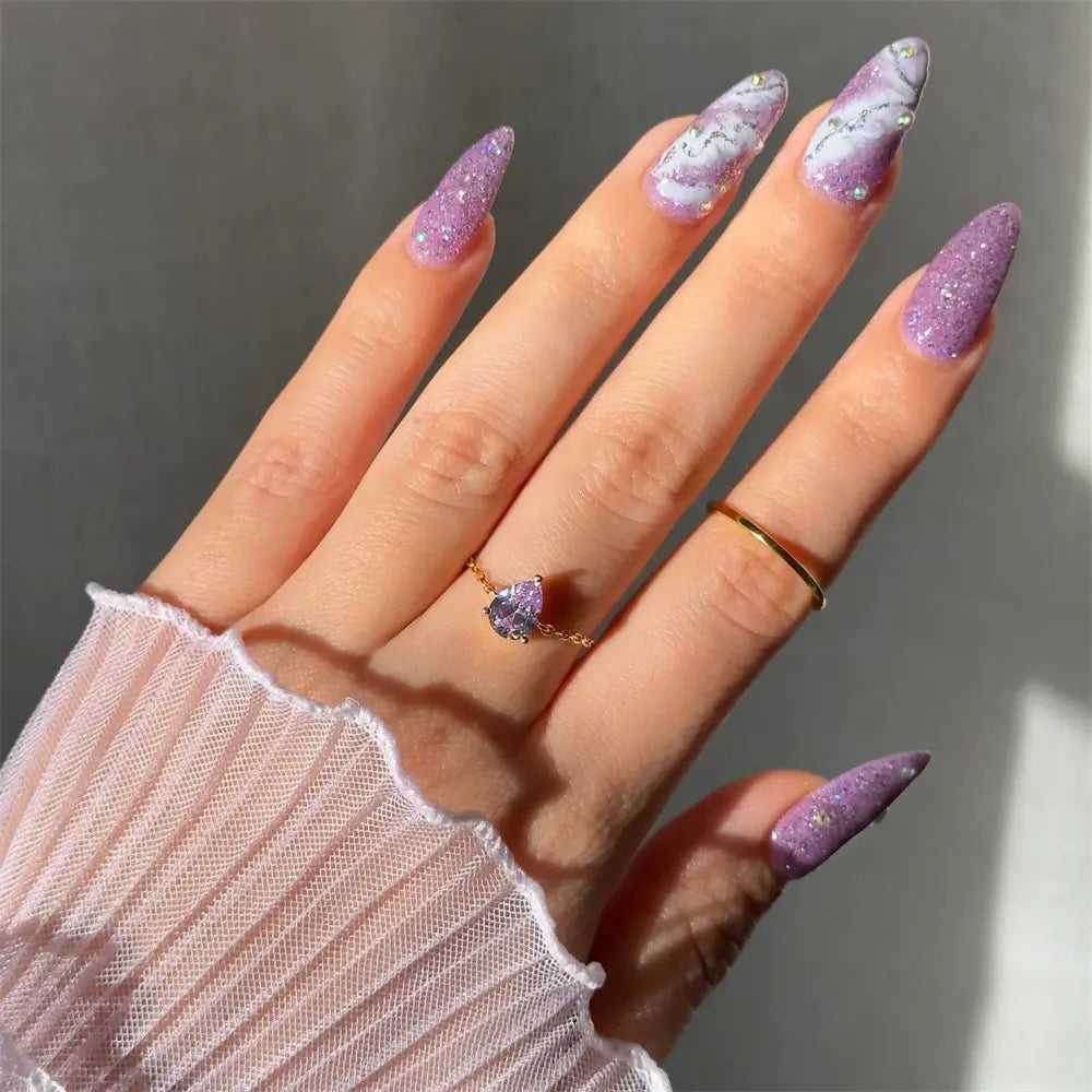 925 sterling silver heart-shaped ring with purple zirconia, worn by model with purple glitter nails.