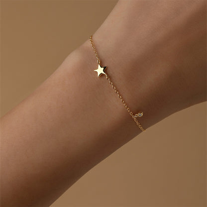 Close-up of a model's wrist wearing a 925 sterling silver bracelet with a five-pointed star design.