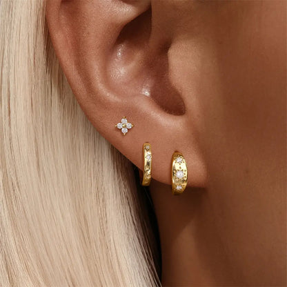 Model wearing 925 sterling silver star and flower earring set, featuring floral studs and star-studded hoops.