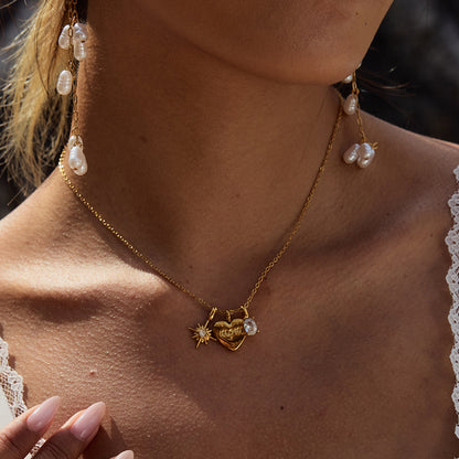Woman wearing gold mom pendant necklace outdoors in natural light