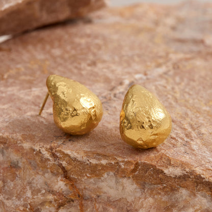 Sculptural gold earrings designed for waterproof wear