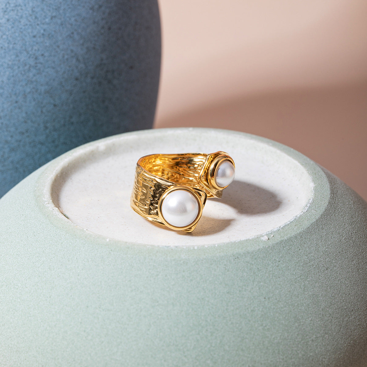 pearl open ring displayed on ceramic plate in studio setting