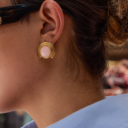 Model wearing pink cat eye stone stud earrings, minimal retro style for everyday wear