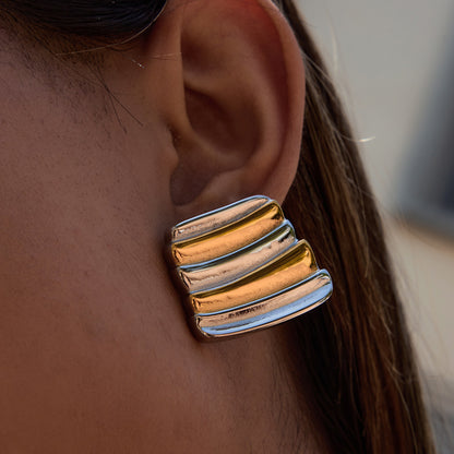 two-tone earrings styled on model under sunlight