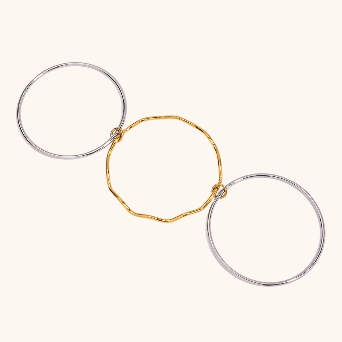 Close-up of wavy gold accent on silver bracelet stack