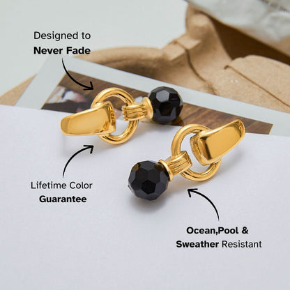 Modern drop earrings with faceted black bead and gold finish