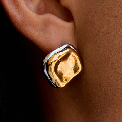 bold asymmetric square earrings worn on model with natural makeup