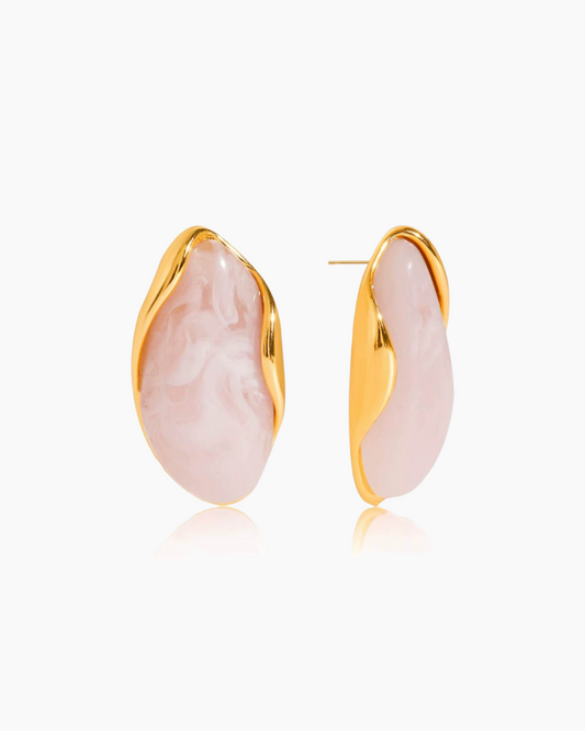 Pink earrings with gold posts on a white background