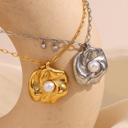 Gold flower pendant necklace with pearl, styled with a chunky chain