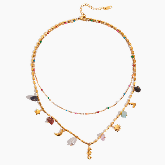 Gold necklace with colorful charms on a white background