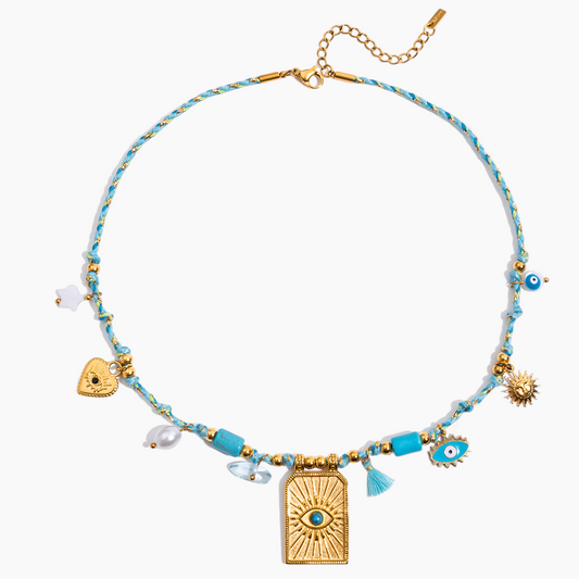 Necklace with blue beads and gold accents on a white background