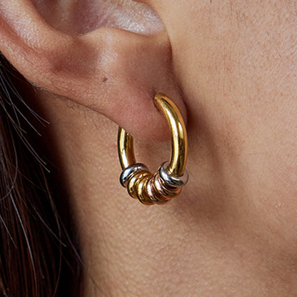 Model wearing chunky beaded hoop earrings