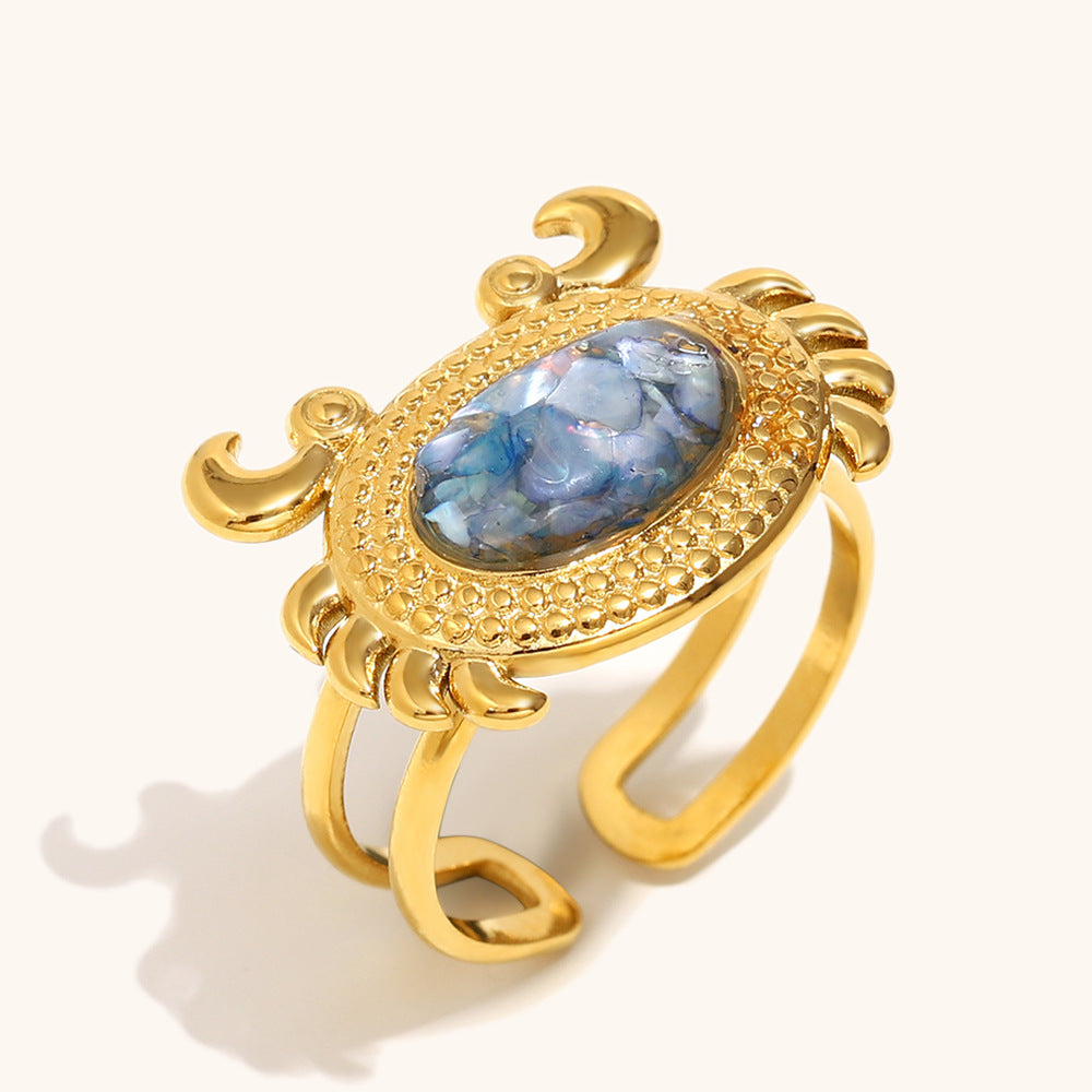 Blue shell inlay crab ring in gold-tone finish, playful and elegant.