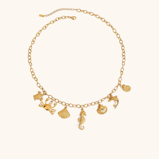 Gold chain necklace with seahorse and sea creature charms, perfect for beach outfits