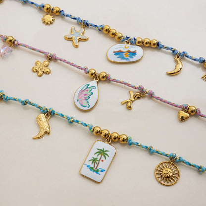Flatlay of three tropical necklaces with ceramic center charms