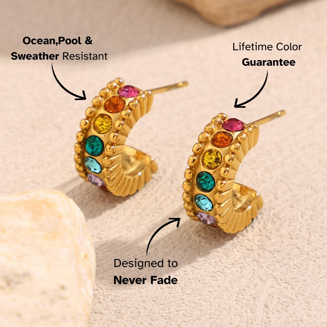 Waterproof rainbow gemstone hoop earrings with vibrant sparkle on natural surface