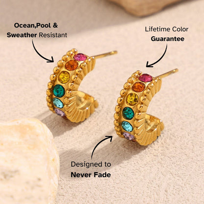Waterproof rainbow gemstone hoop earrings with vibrant sparkle on natural surface