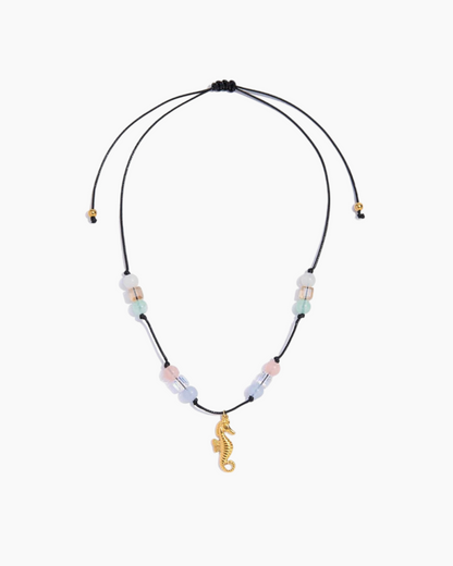 Necklace with seahorse charm and multicolored beads on a white background