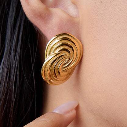 Model wearing bold gold waterproof stud earrings for everyday style