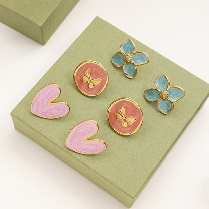 Blue floral and butterfly round earrings with swirl pattern