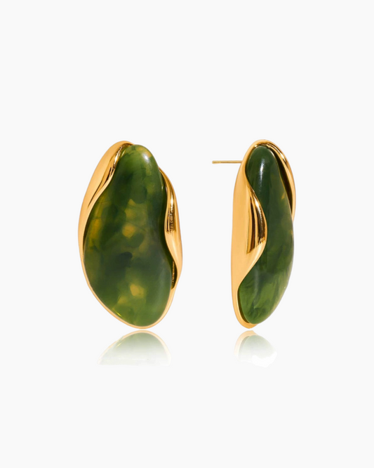 Pair of green stone earrings with gold accents on a white background
