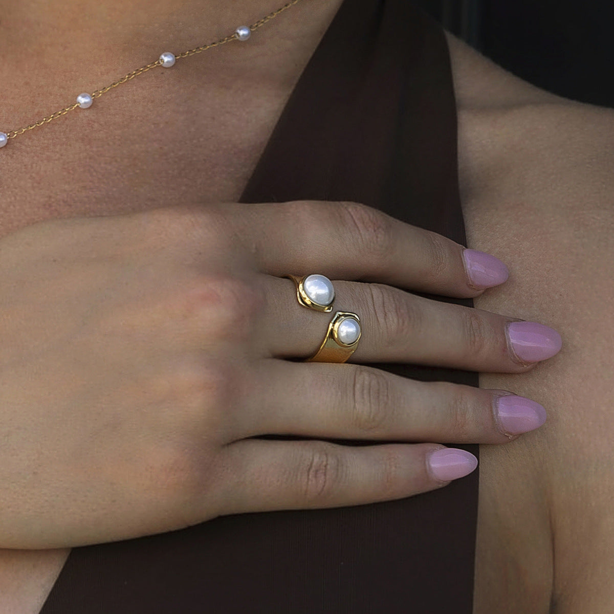 close-up of model hand showing twin pearl statement ring