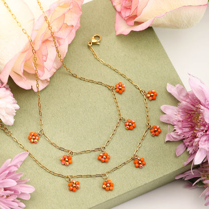 Orange crystal flower necklace close-up with pink rose and gift box