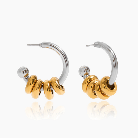 Pair of hoop earrings with gold and silver beads on a white background