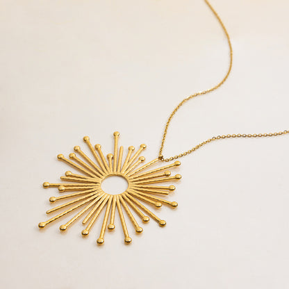 detailed shot of gold rays pendant with round center