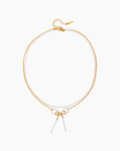 Gold and white beaded necklace on a white background