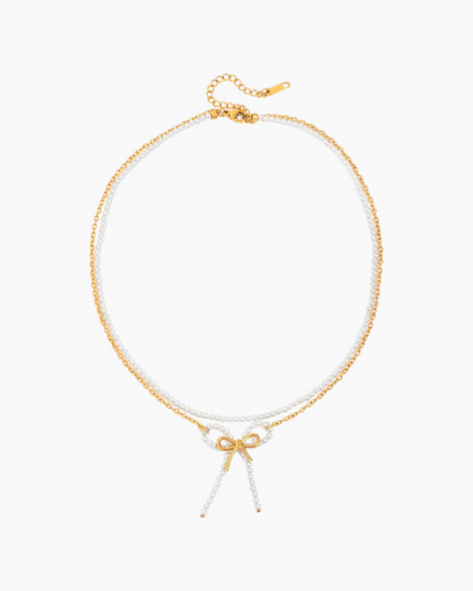 Gold and white beaded necklace on a white background