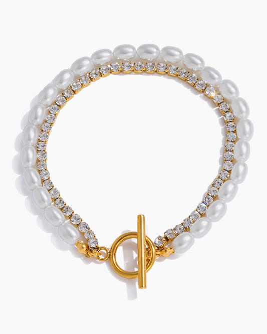 Pearl bracelet with gold clasp on a white background