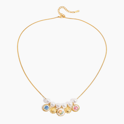 Gold necklace with colorful charms and pearl-like beads on a white background