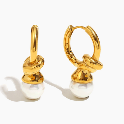 Close-up of gold pearl knot hoop earrings with elegant details