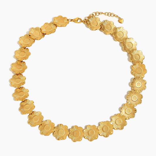 Gold floral necklace on a white background