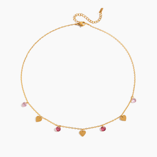 Gold necklace with heart-shaped pendants on a white background