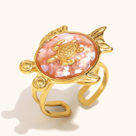 Gold turtle ring with pink abalone shell texture and fish tail frame
