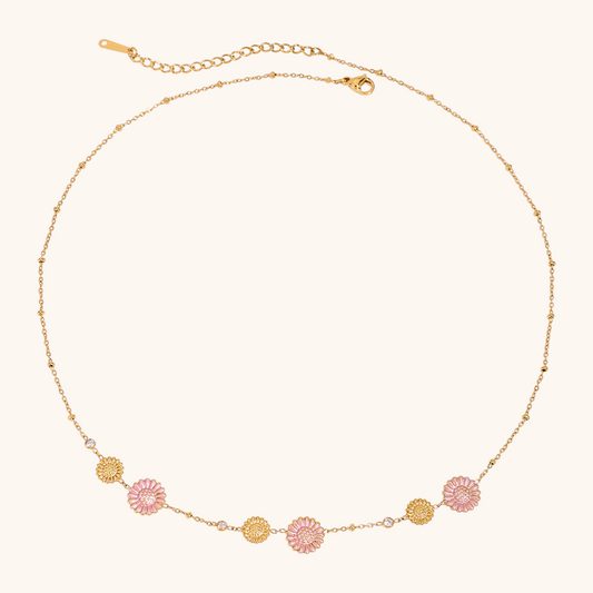 Close-up of pink daisy choker necklace with gold chain