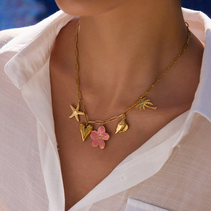 Zoom-in of model's neck showing layered summer charm necklace