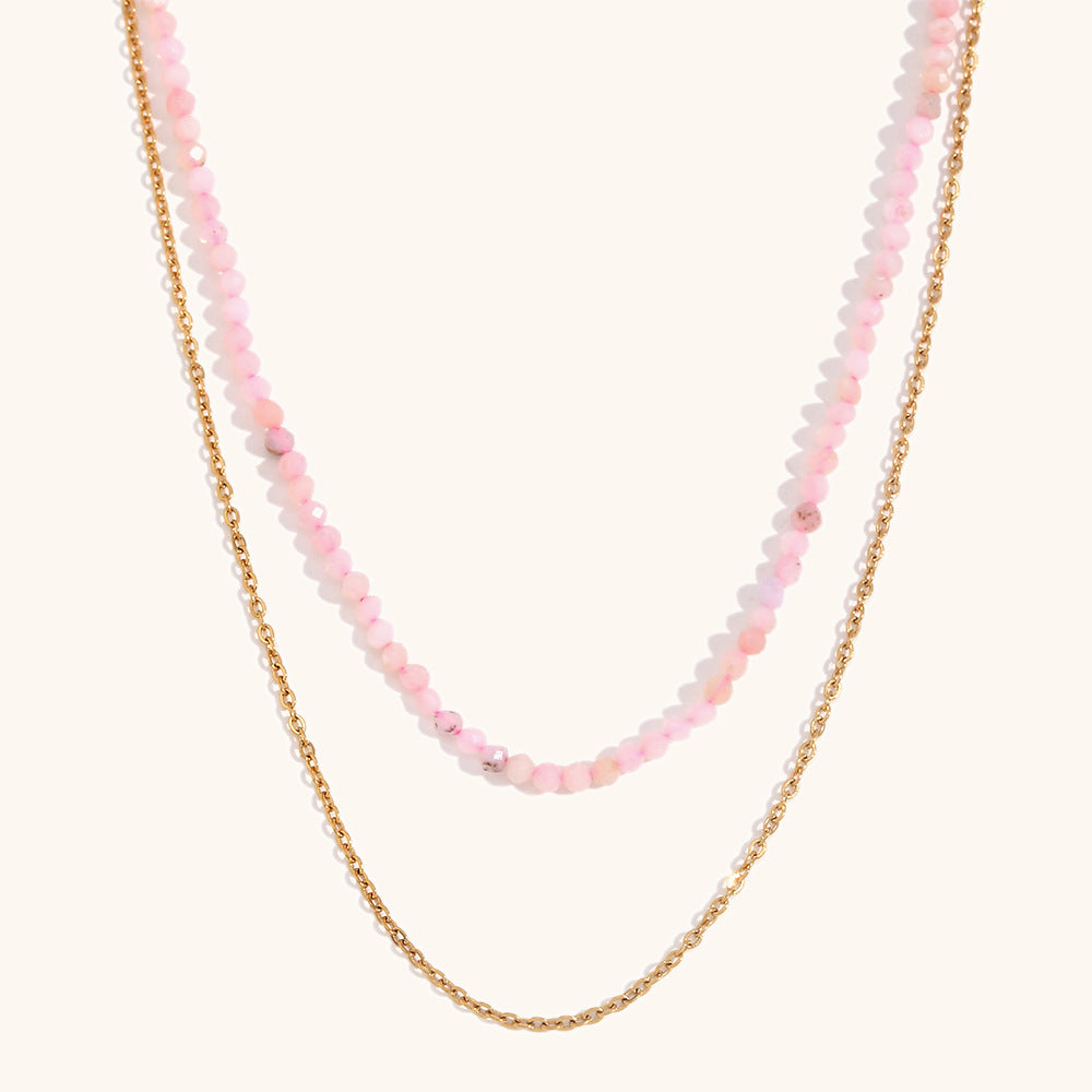 Feminine pink double-strand necklace featuring round-cut crystals and gold accents