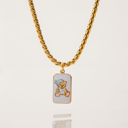 Full view of teddy bear pendant necklace on gold curb chain with lobster clasp