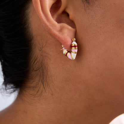 Model wearing one pink heart enamel earring, showing vibrant colors and snug fit